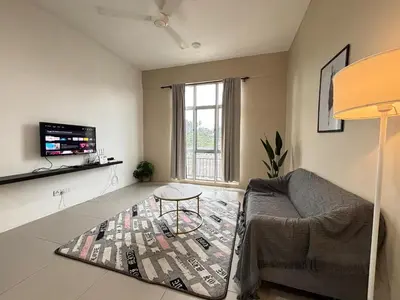 a living room with a couch and a table at JS Comfortable Stay Golden Hills Pasar Malam Studio in Brinchang