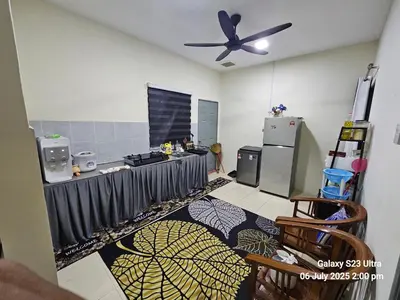 a kitchen with a table and a ceiling fan at Homestay ZAF sitiawan in Sitiawan