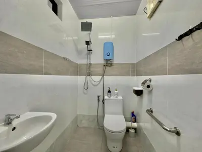 a bathroom with a toilet and a sink at Spacious 2 Storey Homestay Tanjung Bungah 25Pax by 3C in Tanjung Bungah