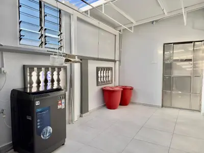 a large room with two red trash cans in it at Spacious 2 Storey Homestay Tanjung Bungah 25Pax by 3C in Tanjung Bungah