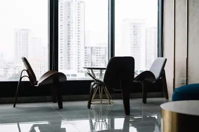 a room with three chairs and a table in front of a window at Seaview Infinity Pool 3BR 8Pax 2Carpark 211 in George Town