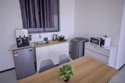 a small kitchen with a table and a microwave at Seaview Infinity Pool 3BR 8Pax 2Carpark 211 in George Town