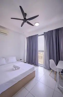 a bedroom with a bed and a ceiling fan at Seaview Infinity Pool 3BR 8Pax 2Carpark 211 in George Town