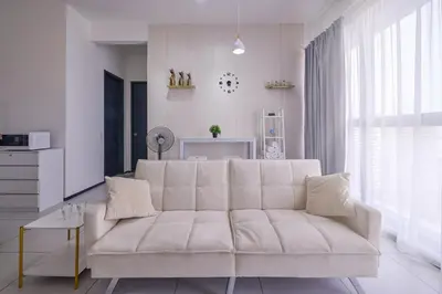 a white living room with a white couch and a table at Seaview Infinity Pool 3BR 8Pax 2Carpark 211 in George Town