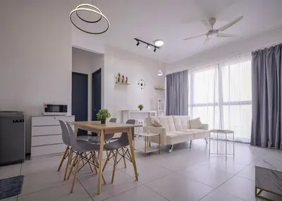 a kitchen and living room with a table and chairs at Seaview Infinity Pool 3BR 8Pax 2Carpark 211 in George Town