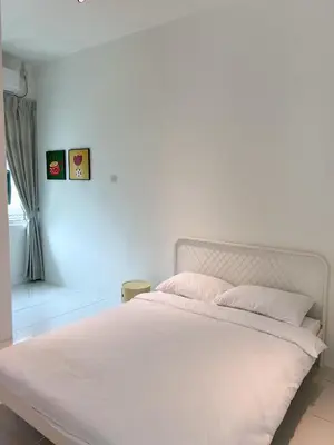 a white bed with white sheets and pink pillows at Lake Grove 17 near Tambun 4BR - 8 PAX in Kampong Batu Lapan