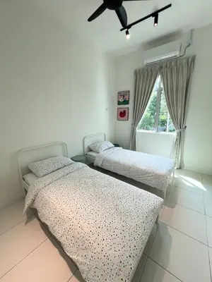 two beds in a bedroom with a ceiling fan at Lake Grove 17 near Tambun 4BR - 8 PAX in Kampong Batu Lapan