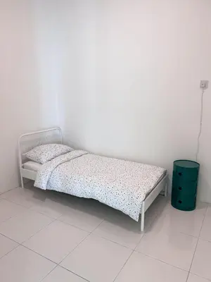 a bed in a room with a white wall at Lake Grove 17 near Tambun 4BR - 8 PAX in Kampong Batu Lapan