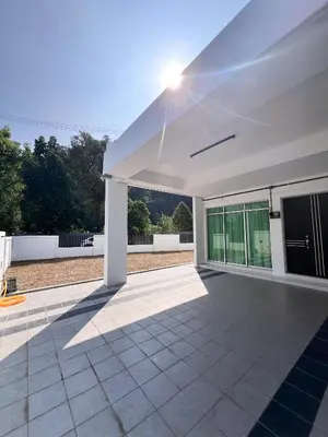 a white house with the sun shining on a patio at Lake Grove 17 near Tambun 4BR - 8 PAX in Kampong Batu Lapan