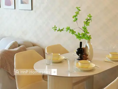 a white table with yellow chairs and a vase on it at StarviewBay Forest City 2B1R Cozy Condo in Gua Sai