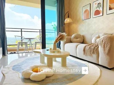 a living room with a white couch and a table at StarviewBay Forest City 2B1R Cozy Condo in Gua Sai