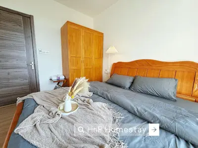 a bedroom with a bed with a wooden headboard at StarviewBay Forest City 2B1R Cozy Condo in Gua Sai