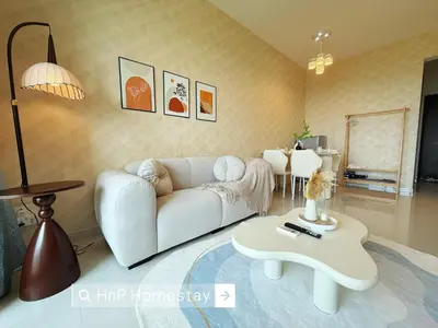 a living room with a white couch and a coffee table at StarviewBay Forest City 2B1R Cozy Condo in Gua Sai