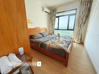 a bedroom with a bed and a large window at StarviewBay Forest City 2B1R Cozy Condo in Gua Sai