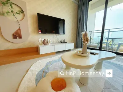 a living room with a tv and a coffee table at StarviewBay Forest City 2B1R Cozy Condo in Gua Sai