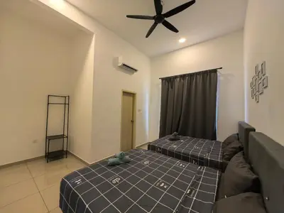 a bedroom with two beds and a ceiling fan at Padang Serai Wangi Roomstay 95 in Padang Serai