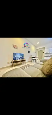 a bedroom with two beds and a flat screen tv at Cybersquare Vertex Tower in Gua Sai