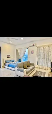 a large bedroom with a bed and a couch at Cybersquare Vertex Tower in Gua Sai
