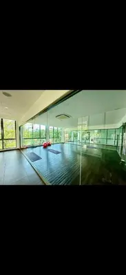 a large empty room with glass walls in a building at Cybersquare Vertex Tower in Gua Sai