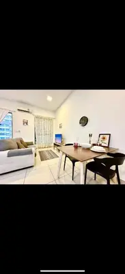 a living room with a couch and a table at Cybersquare Vertex Tower in Gua Sai