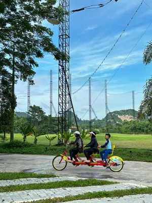 a group of three people riding on a bike at Glamping at Xscape Tambun in Ipoh