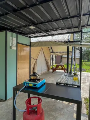 a tent with a grill and a table with a stove at Glamping at Xscape Tambun in Ipoh