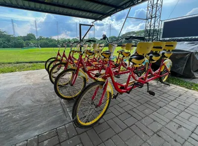 a row of red bikes parked next to each other at Glamping at Xscape Tambun in Ipoh