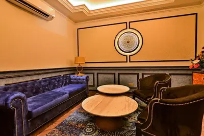 a living room with a couch and a large screen at Bertam Wellness Spa & Villas - A Member of Small Luxury Hotels of the World in Kepala Batas