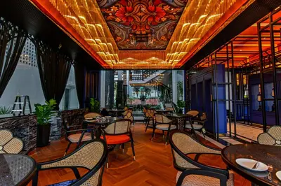 a restaurant with tables and chairs and a ceiling at Bertam Wellness Spa & Villas - A Member of Small Luxury Hotels of the World in Kepala Batas