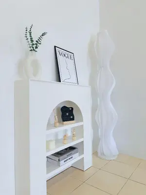a white book shelf in a white room with a plant at BM Alma AutoCity Aeonjusco in Bukit Mertajam