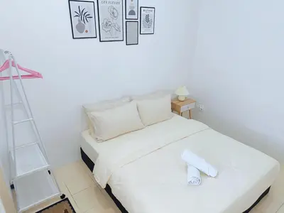 a white bed in a room with a ladder at BM Alma AutoCity Aeonjusco in Bukit Mertajam