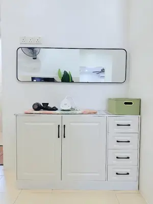 a white cabinet with a mirror in a room at BM Alma AutoCity Aeonjusco in Bukit Mertajam