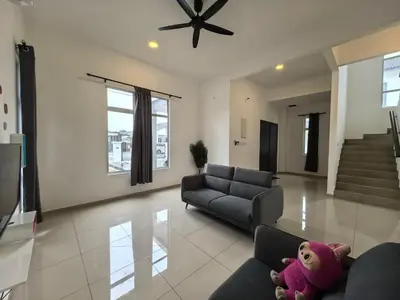 a living room with a couch and a stuffed animal at Family Room with Private Bathroom in Padang Serai