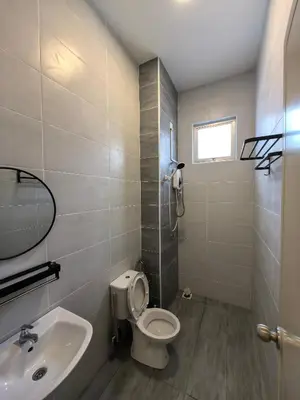 a bathroom with a toilet and a sink at Family Room with Private Bathroom in Padang Serai