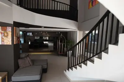 a living room with a couch and a staircase at Mornington Hotel Waterfront Lumut in Lumut