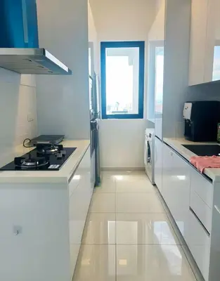 a white kitchen with a stove and a window at Beacon #2BR FamilyStay #22Georgetown in George Town
