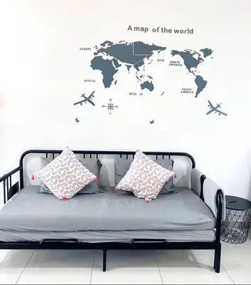 a map of the world on a wall with a couch at Beacon #2BR FamilyStay #22Georgetown in George Town