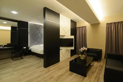 a hotel room with a bed and a desk at De Parkview Hotel in Ipoh