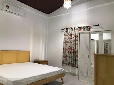 a bedroom with a bed and a shower curtain at As Sufi Village in Kampung Sungai Air Tawar