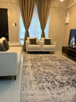 a living room with two couches and a rug at Homestay Taman Scientex Kota Tinggi in Gua Sai