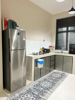 a kitchen with a stainless steel refrigerator in it at Homestay Taman Scientex Kota Tinggi in Gua Sai