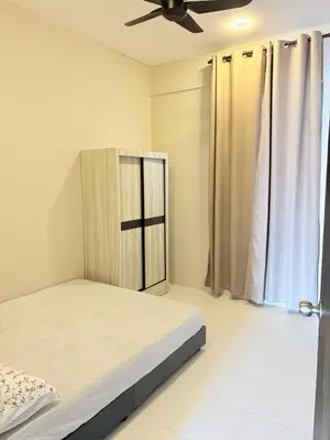a bedroom with a bed and a ceiling fan at Homestay Taman Scientex Kota Tinggi in Gua Sai