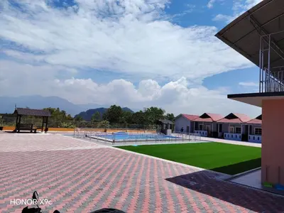a building with a tennis court and a green field at SkyView Village Ulu Chemor in Chemor