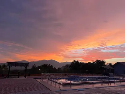 a group of benches with a sunset in the background at SkyView Village Ulu Chemor in Chemor