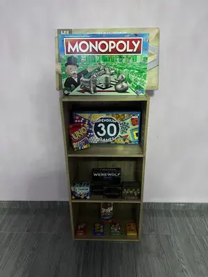 a book shelf with a monopoly game on it at SkyView Village Ulu Chemor in Chemor