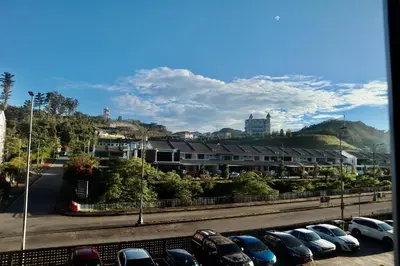 a row of parked cars in a parking lot at Kareena Barrington Square Goldenhills Pasar Malam Cameron Highlands in Brinchang