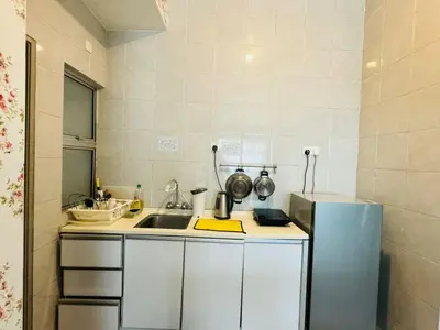 a small kitchen with a sink and a refrigerator at Kareena Barrington Square Goldenhills Pasar Malam Cameron Highlands in Brinchang