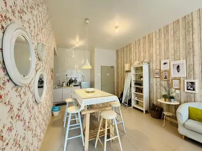 a kitchen and living room with a table and chairs at Kareena Barrington Square Goldenhills Pasar Malam Cameron Highlands in Brinchang