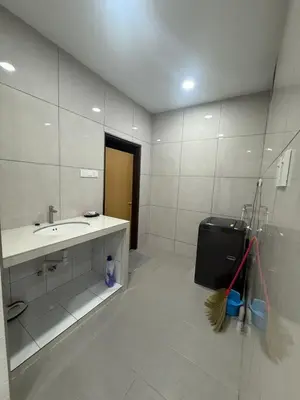 a white bathroom with a sink and a mirror at Happy Guest House Taman Cowin Nibong Tebal \u5f00\u5fc3\u6c11\u5bbfTaman Cowin\u9ad8\u6e0a\u533a in Nibung Tebal