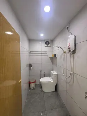 a small bathroom with a toilet and a shower at Happy Guest House Taman Cowin Nibong Tebal \u5f00\u5fc3\u6c11\u5bbfTaman Cowin\u9ad8\u6e0a\u533a in Nibung Tebal